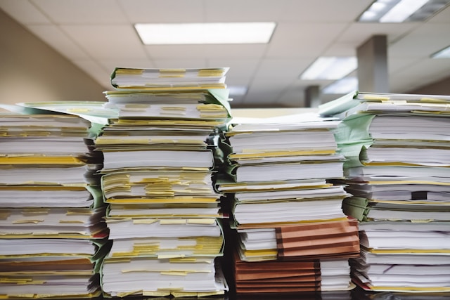 Several stacks of bookkeeping paperwork.